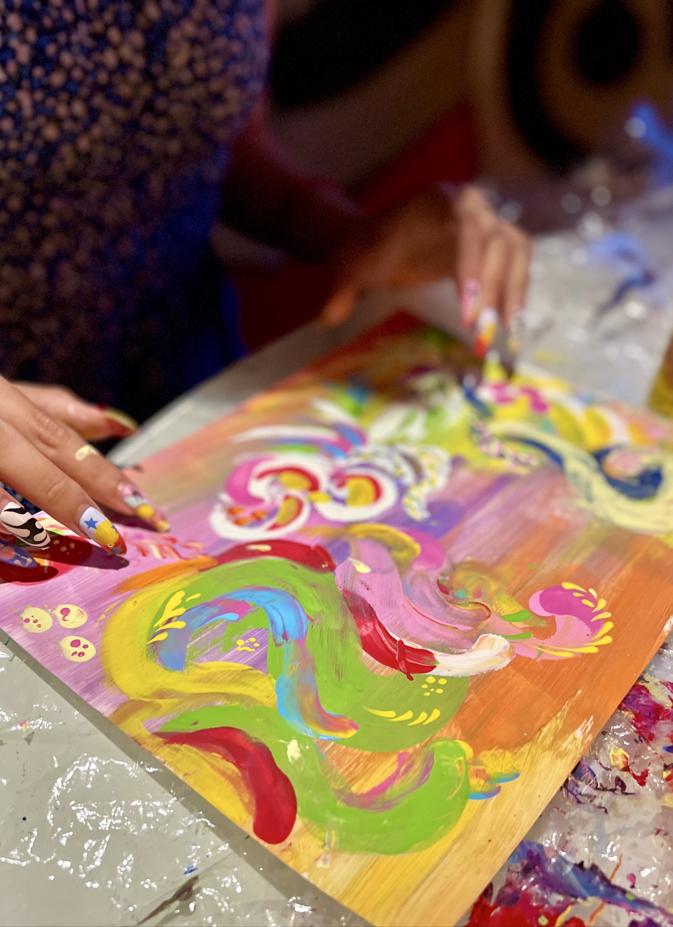 Hands creating an energy painting during an Energy Art Therapy session